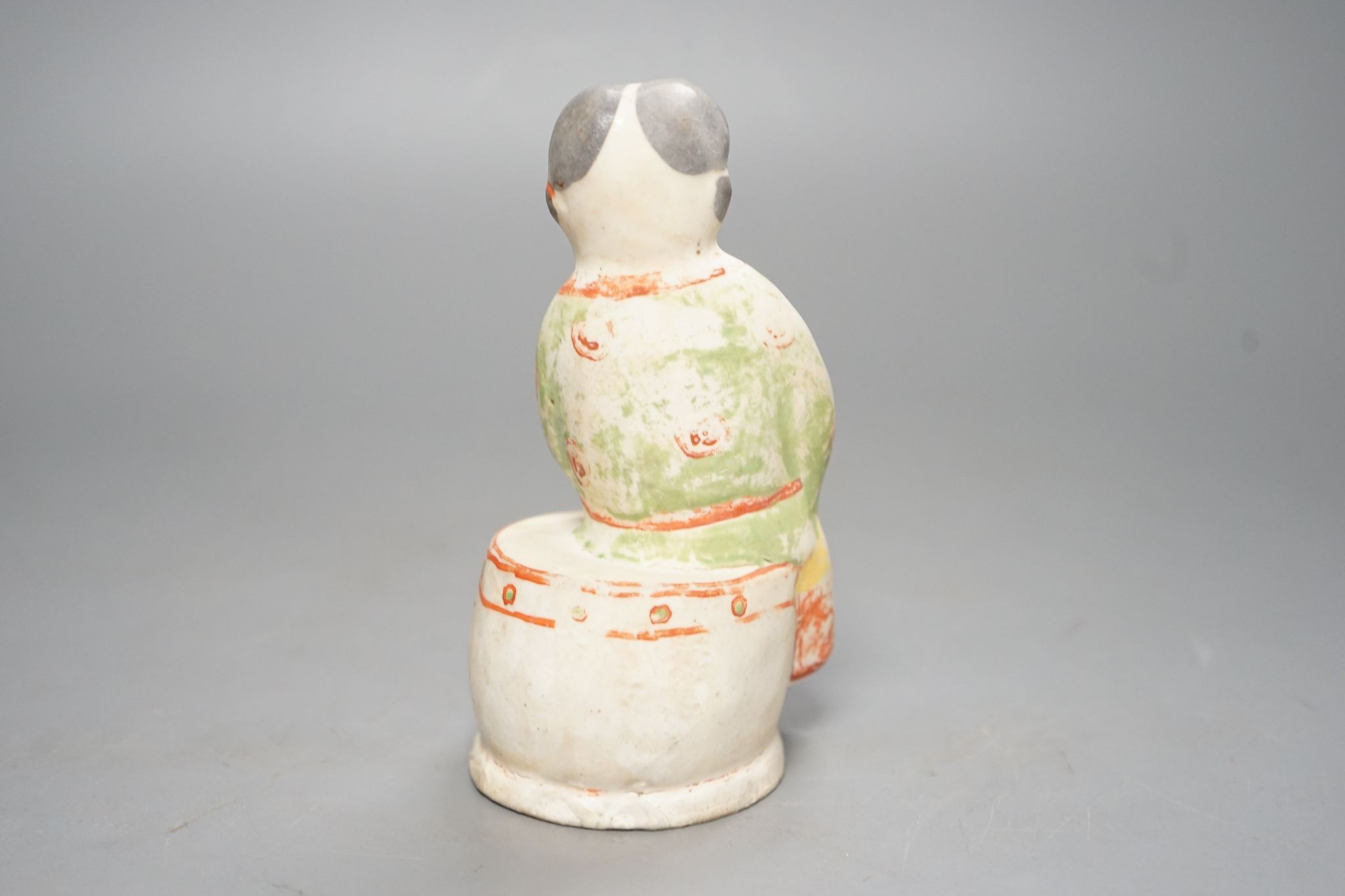 A Chinese Ming cizhou enamelled pottery group of a boy and dog, with case, 14cm